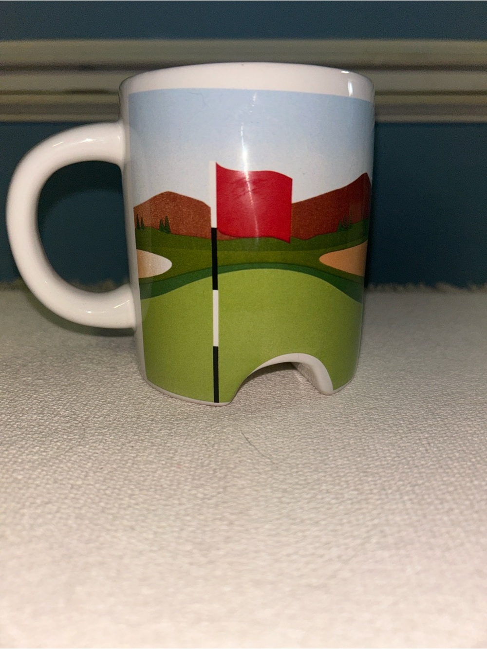Kikkerland White Mug with Red Flag and Green Golf Course Illustration